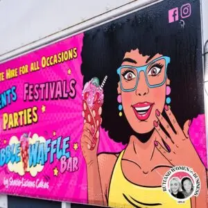 A close-up of The Bubble Waffle Bar’s comic-style branding featuring a woman holding a bubble waffle.