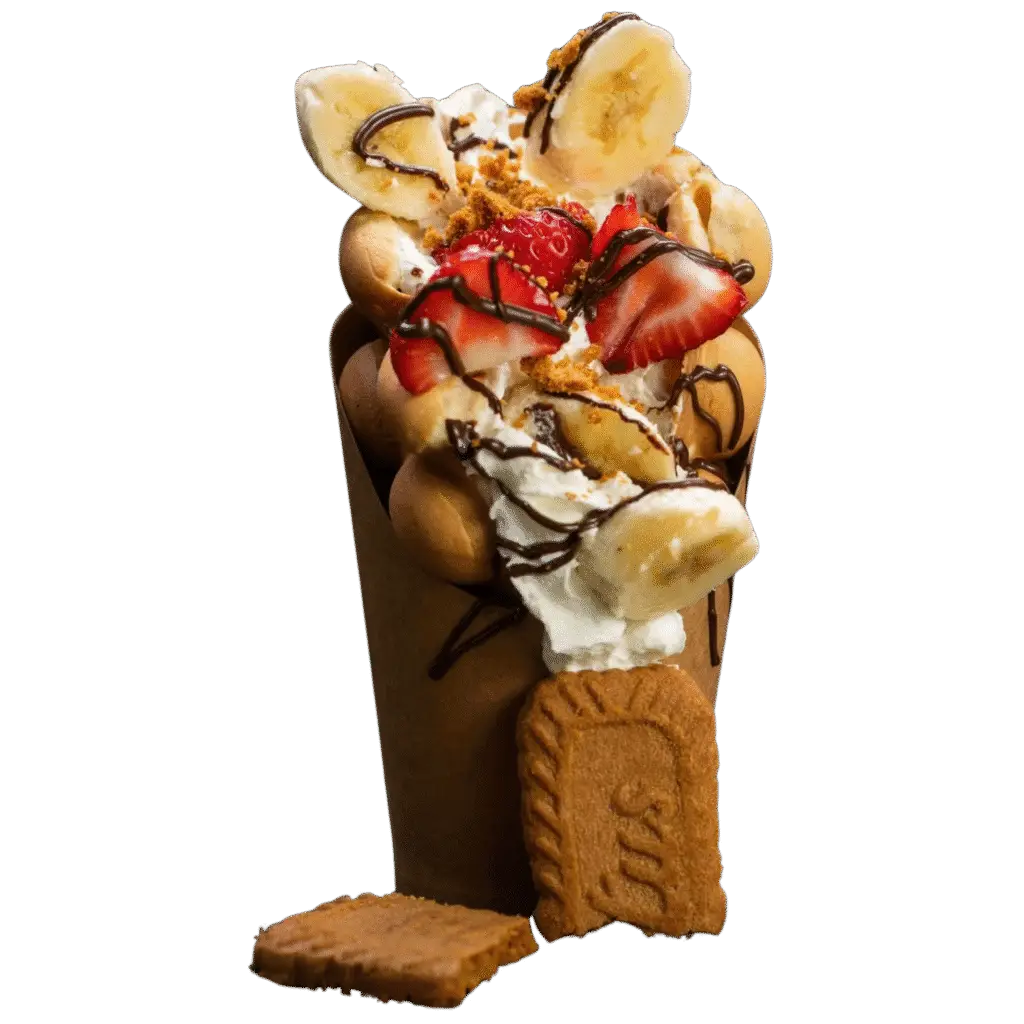 Bubble waffle with banana, strawberries, whipped cream, Biscoff crumbs and a full Biscoff biscuit.